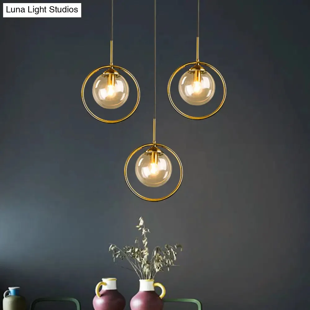 Postmodern Glass Pendant Light with Brass Ring for Bedroom - Single-Bulb Globe Down Lighting in Clear, Amber, and Smoke Grey
