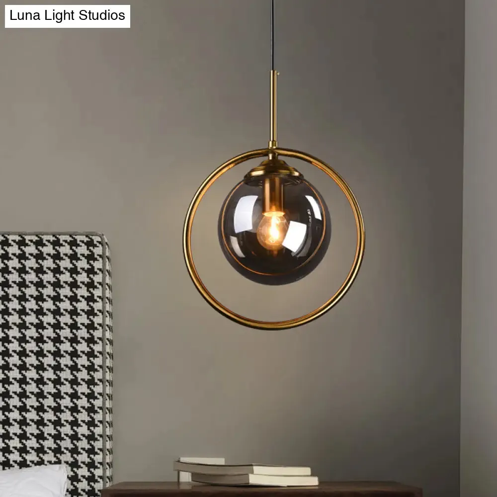 Postmodern Glass Pendant Light with Brass Ring for Bedroom - Single-Bulb Globe Down Lighting in Clear, Amber, and Smoke Grey