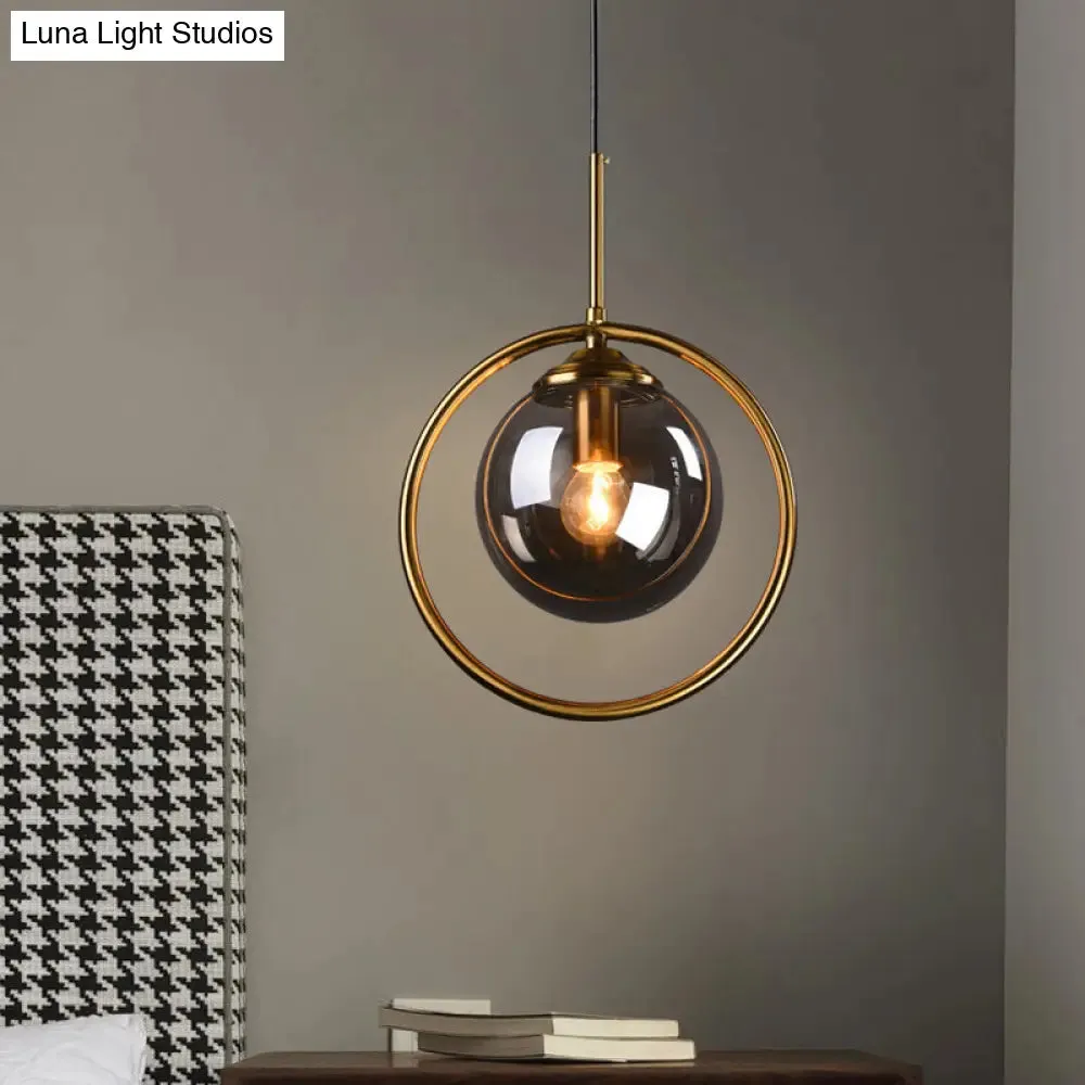 Postmodern Glass Pendant Light with Brass Ring for Bedroom - Single-Bulb Globe Down Lighting in Clear, Amber, and Smoke Grey