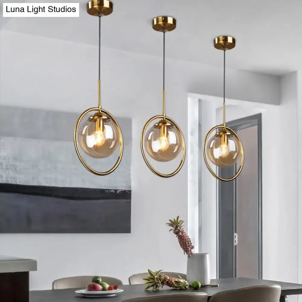 Postmodern Glass Pendant Light with Brass Ring for Bedroom - Single-Bulb Globe Down Lighting in Clear, Amber, and Smoke Grey
