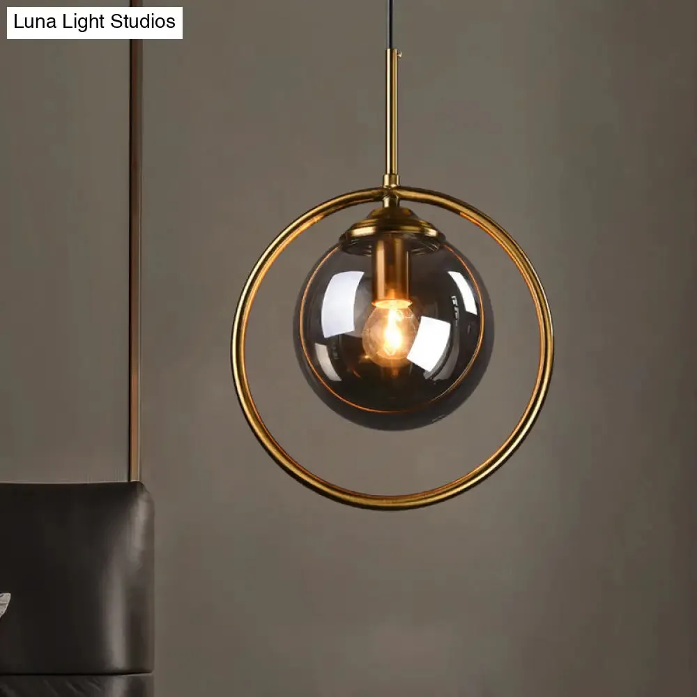 Postmodern Glass Pendant Light with Brass Ring for Bedroom - Single-Bulb Globe Down Lighting in Clear, Amber, and Smoke Grey