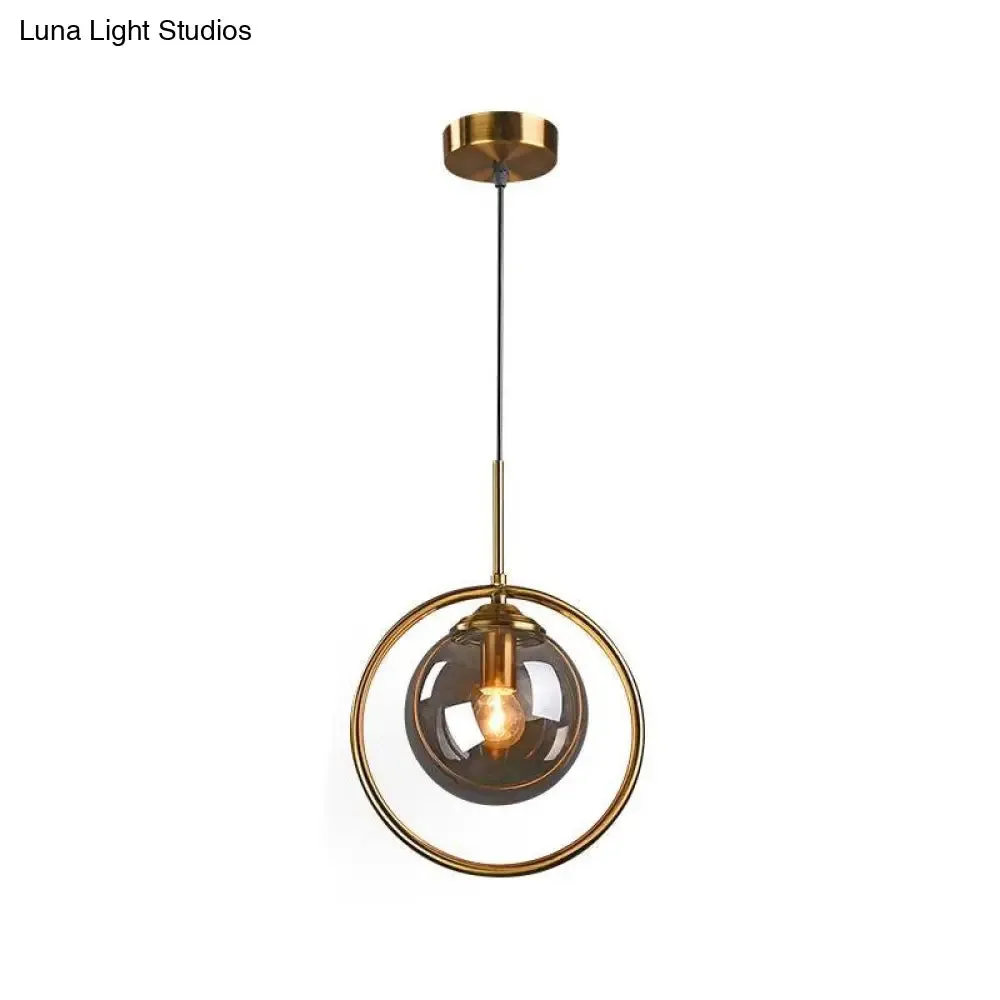 Postmodern Glass Pendant Light with Brass Ring for Bedroom - Single-Bulb Globe Down Lighting in Clear, Amber, and Smoke Grey